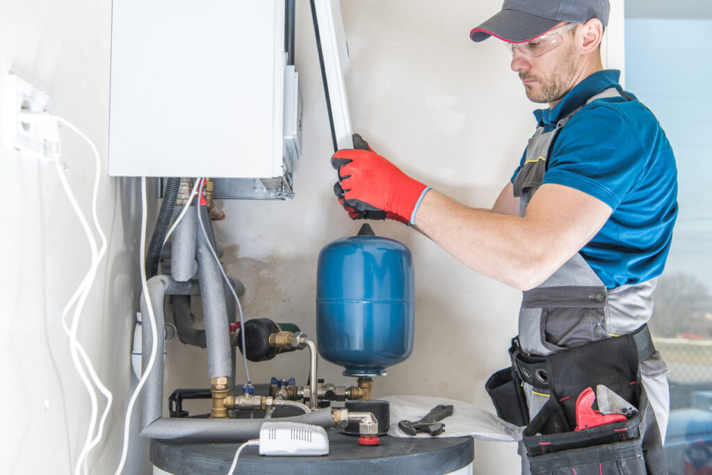 HVAC professional installing an new gas heating system in a home