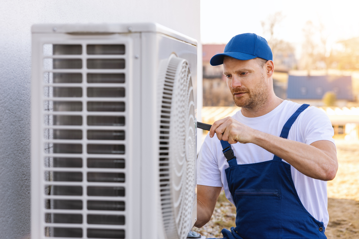 HVAC technician working on a heat pump