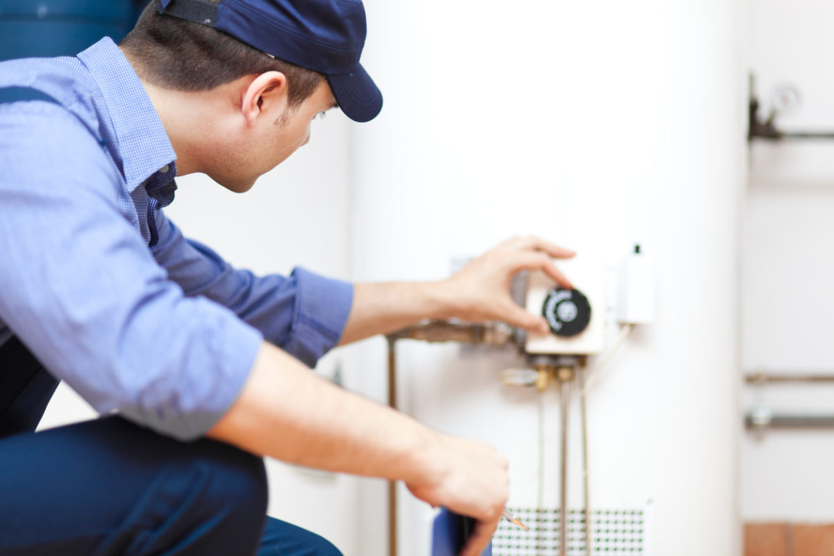 Plumber checking on a water heater after installing it